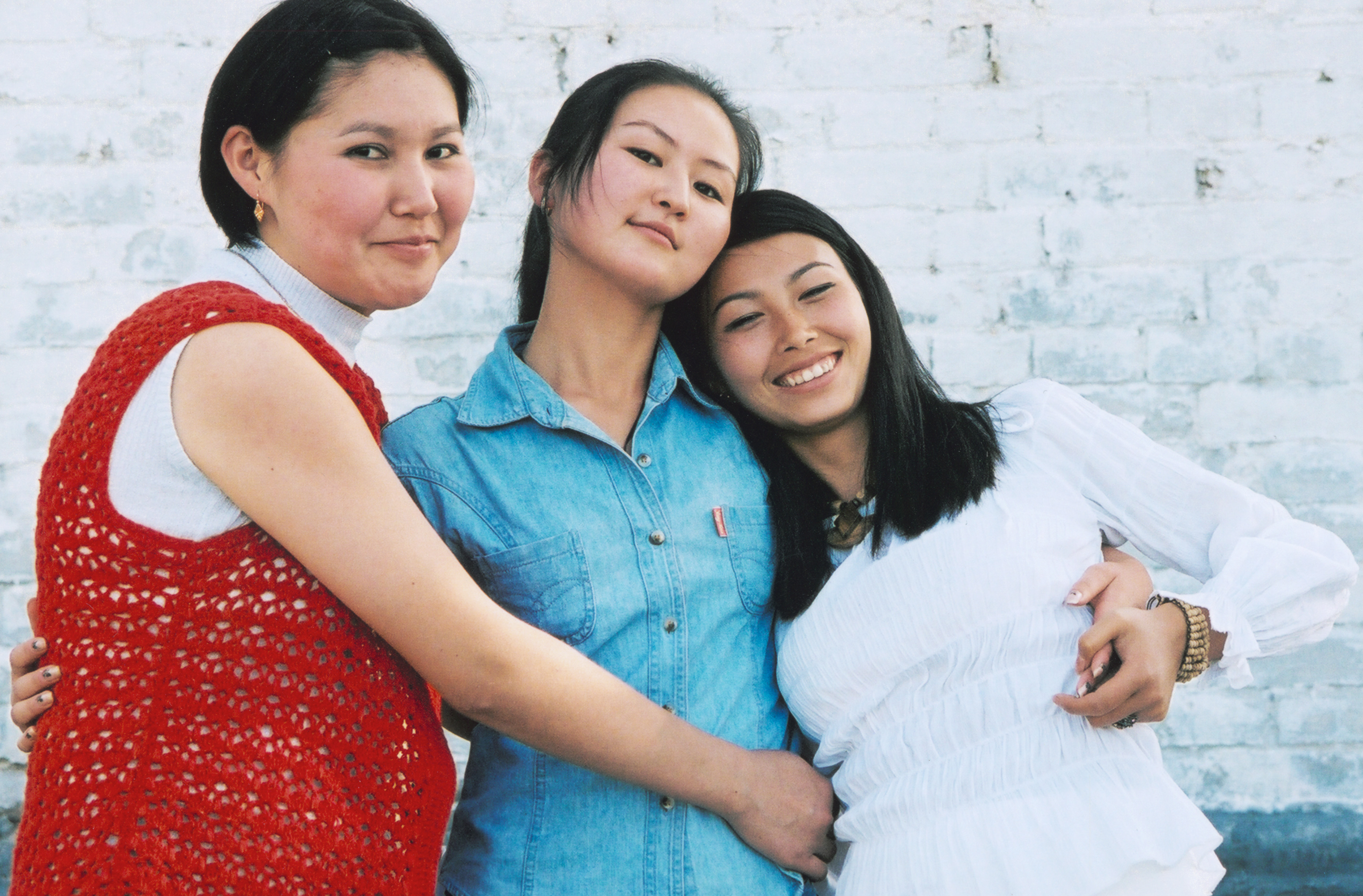 three girls huggin each other
