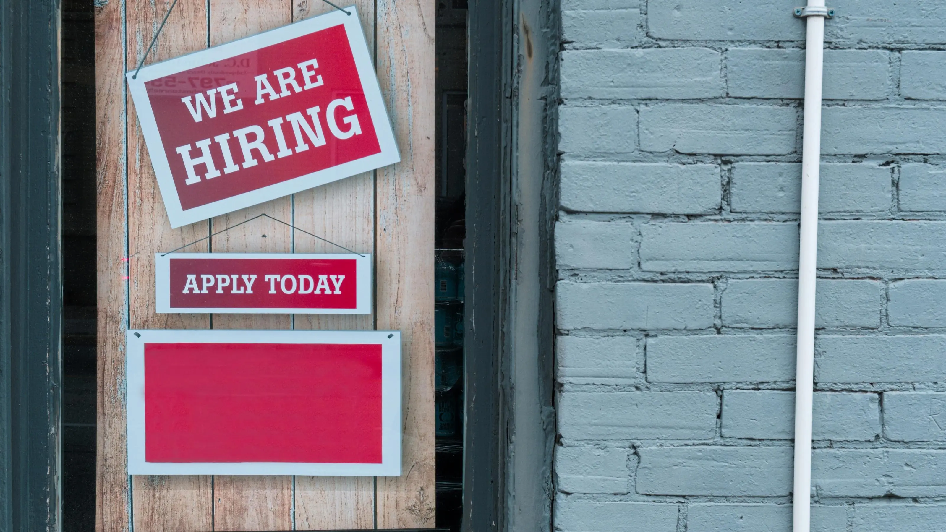 Red 'We Are Hiring' sign