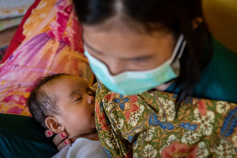 Herlina breastfeeds her baby