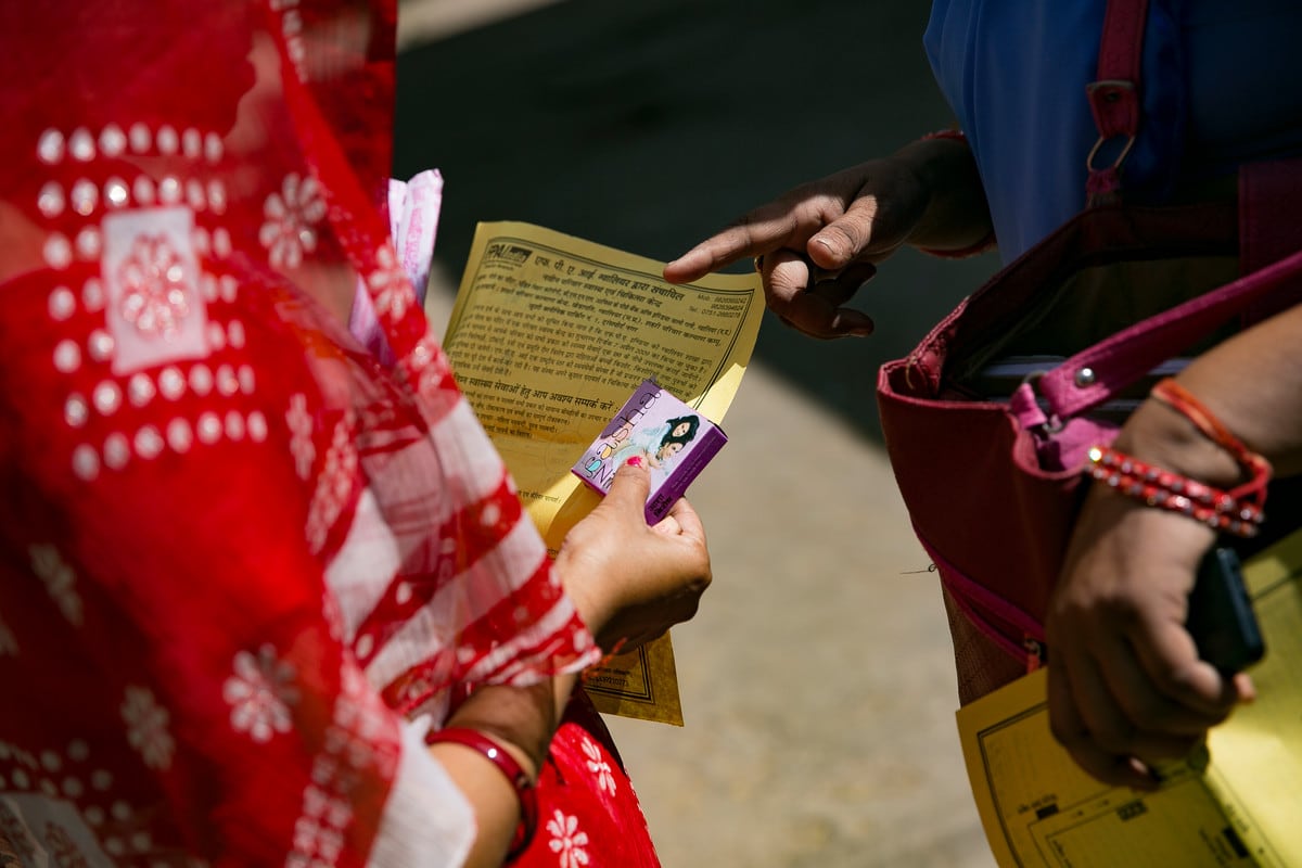 Outreach worker handing out leaflets