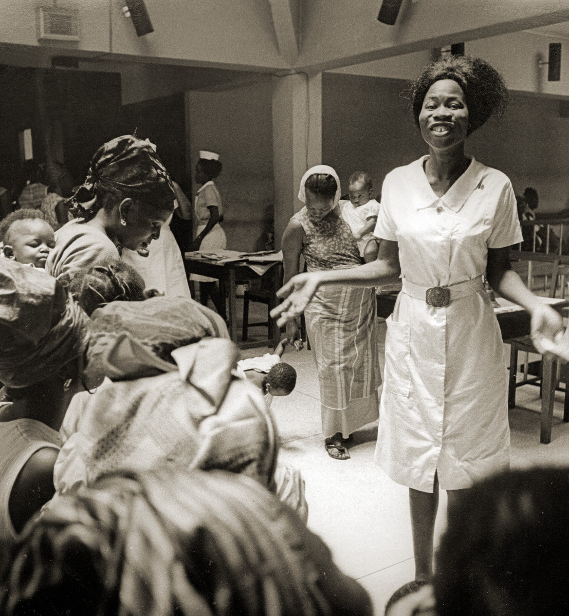 Family planning nurse answering questions at a meeting. Nigeria, 1969