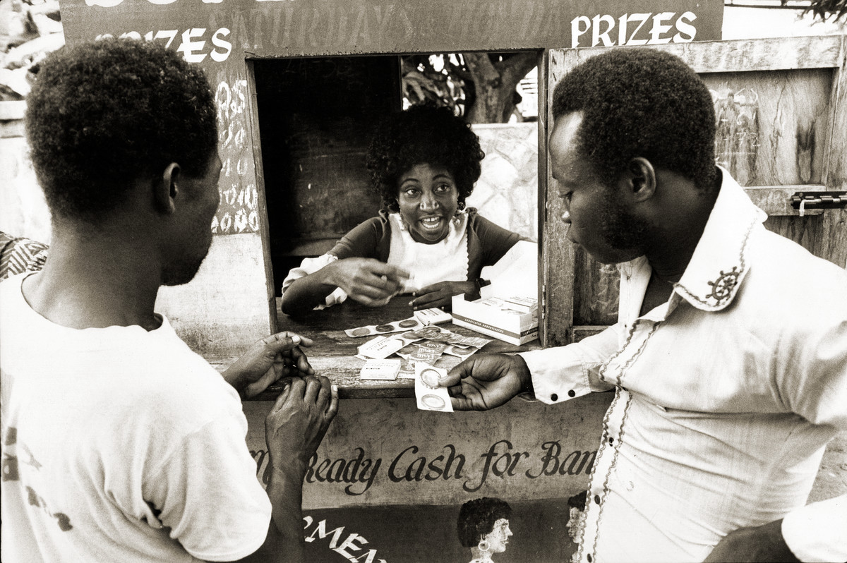 Distributing condoms at a lottery kiosk in Accra. Ghana, 1976