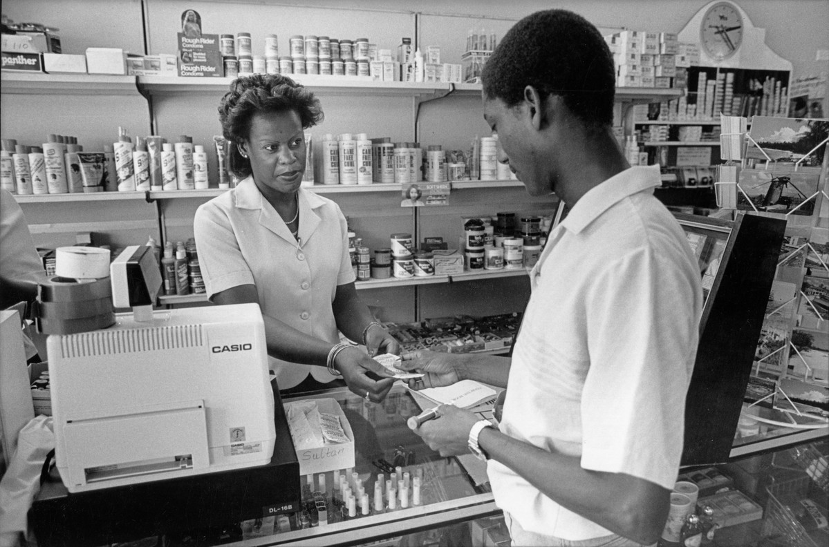 Young man buying contraception supplied by the BFPA to a local supermarket in St James. Barbados 1987