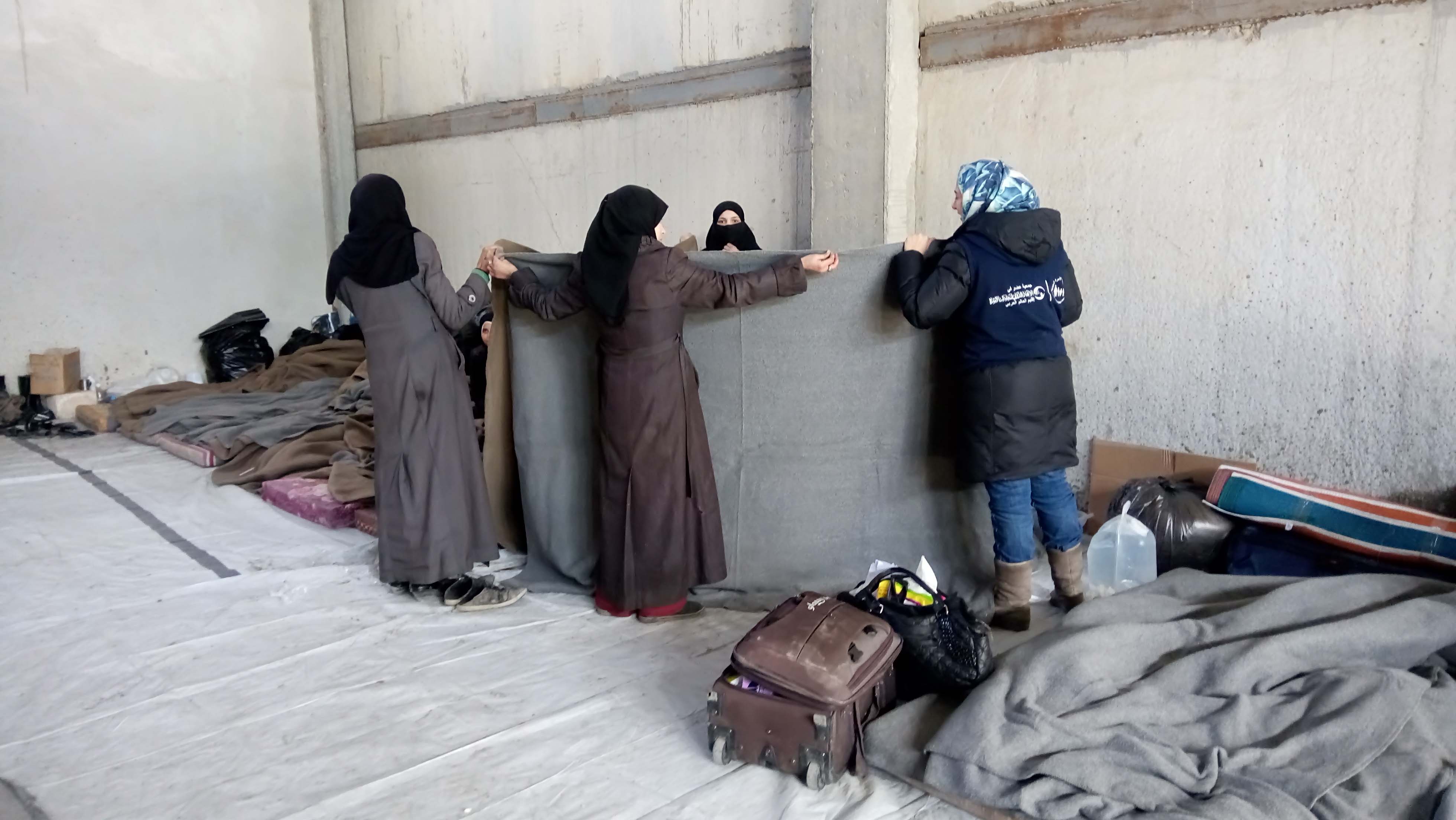  Women use blanket to cover the patients. There's no privacy for them.