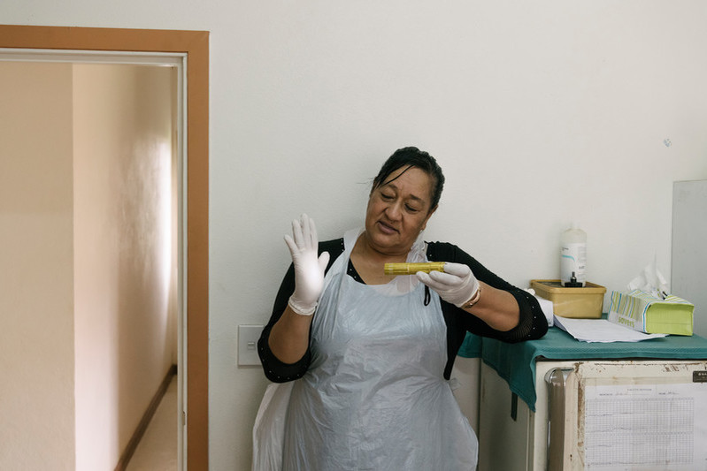 Often equipment can be scarce. In the absence of a portable medical light, nurse Vika, demonstrates the power of the torch she uses for pap smears. 