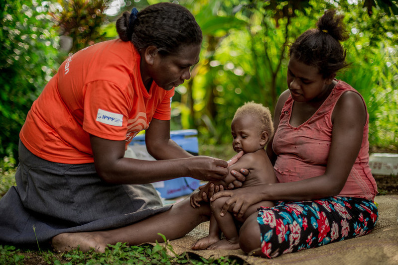 Natalie is seven months pregnant. She lives with her son Johnson high up on the volcano's steep sides. The mobile outreach team visited her village and give vaccinations to her son. "When the volcano started to become active, we could hear the noise of the volcano erupting and see the smoke in the sky. We had to walk down the mountain to Lone, it took many hours," says Natalie. "After I deliver this child I want to get the ‘five-year stick’ [Jadelle]. It will make life easier.” 