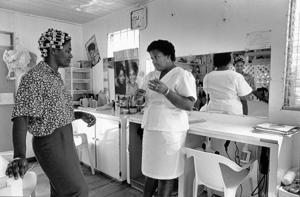 Juliette Simon, counsellor, talking with the owner of a local village hairdessers who is also a community distributor for contraception. St Lucia, 1994