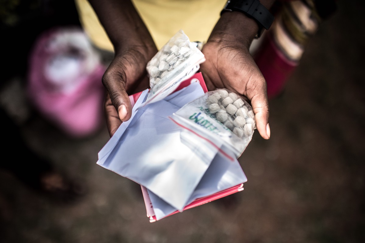 Monica shows the medication she has received from RHU. The ability to receive integrated services in this one stop-shop approach has positively impacted the lives of clients like Monica in Uganda.