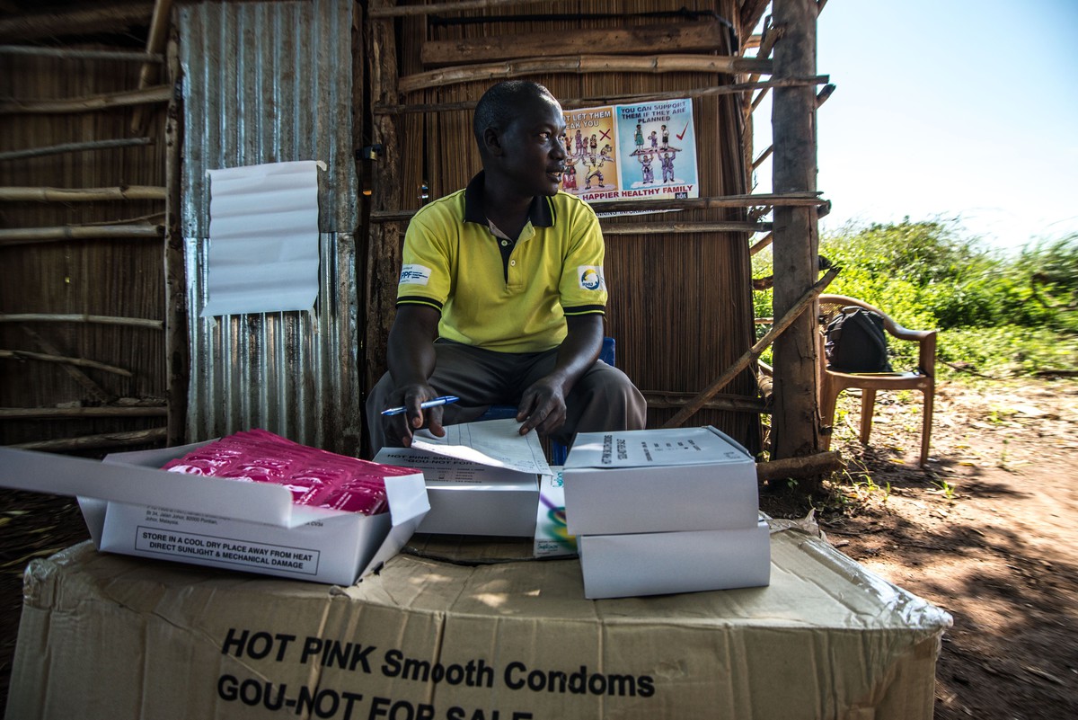 A RHU staff member distributes free condoms. 