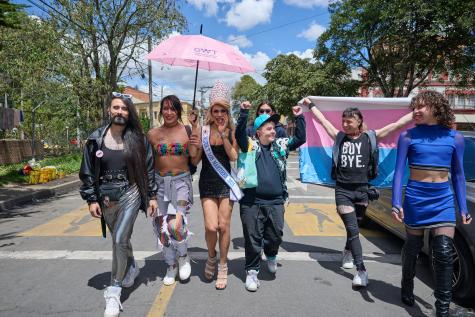 Members of the LGBTQI+ community walk towards the camera in Colombia. They are happy and celebratory. 