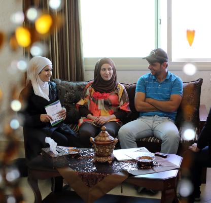 A young couple sit with a counseller