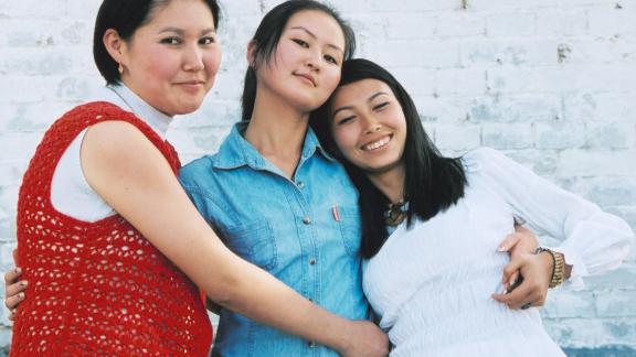 three girls huggin each other