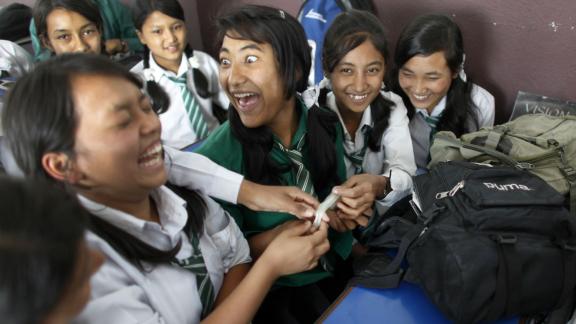 Young people laughing during condom demonstration