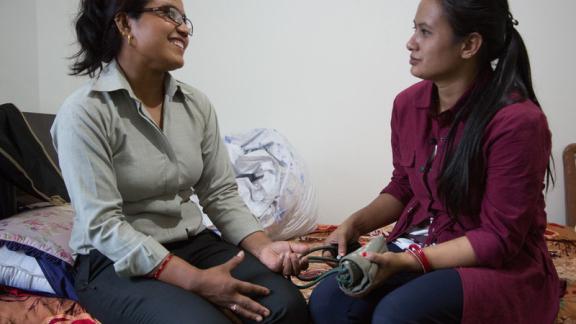 A mother rescued by IPPF in Nepal, FPAN, speaks to a clinician