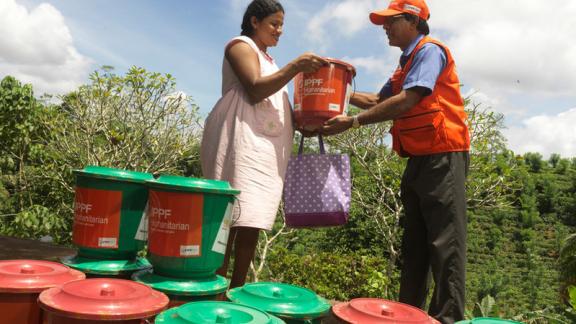 Woman receiving dignity kit. 