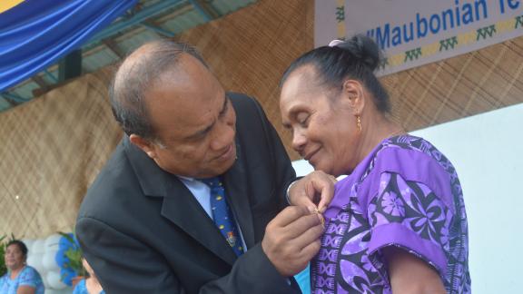 Norma Yeeting receiving her award from President Taneti Mamau