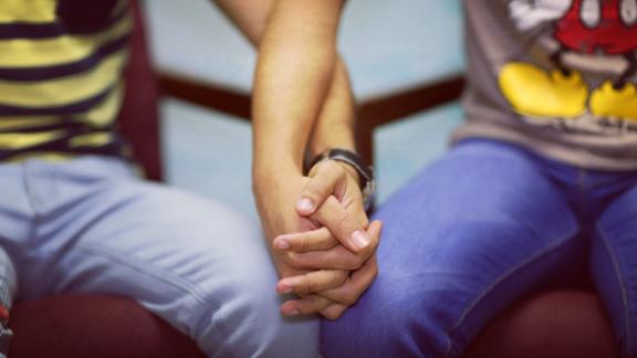 Two people holding hands