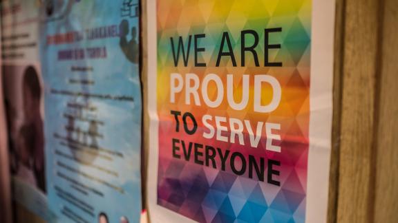 a poster in a clinic stating 'we are proud to serve everyone'
