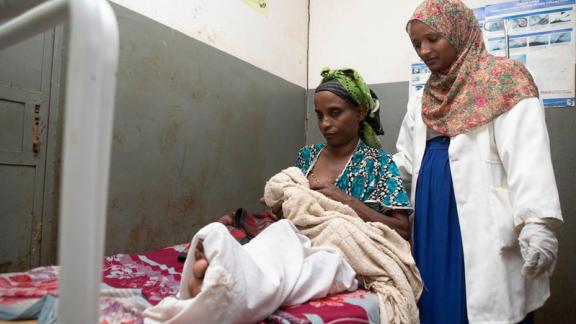 Midwife Rewda Kedir examines a newborn baby and mother in a health center outside of Jimma, Ethiopia