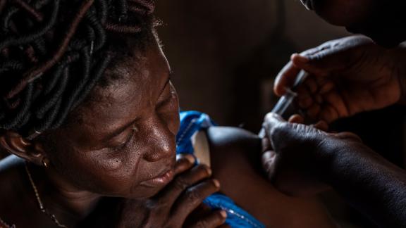 Abla Abassa, community health worker in Ilama gives Essivi Koutchona, 45, the injectable in Ilama village, Togo.