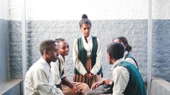 A peer educator in Ethiopia speaks with other young people