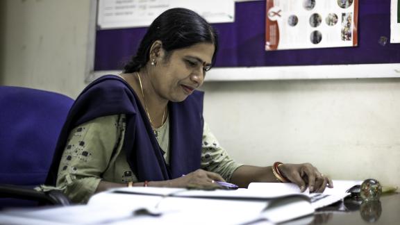 Healthcare worker writing records. 