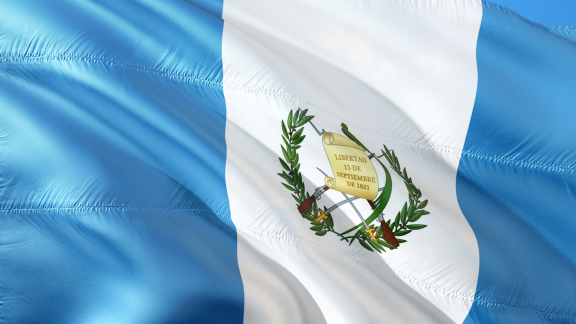 The Guatemalan Flag - striped light blue either side with a white stripe in the middle and a wreath 