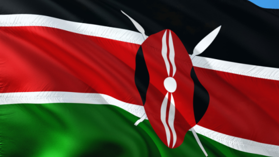The Kenyan flag - black, red and green horizontal stripes with a shield in the middle 