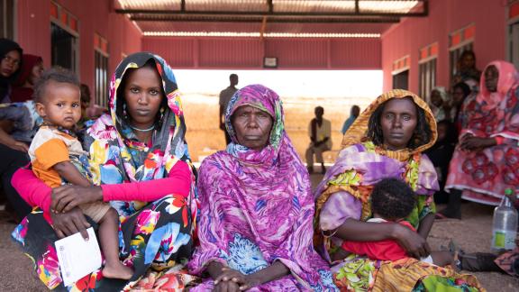Women sitting outside the healthcare clinic. 