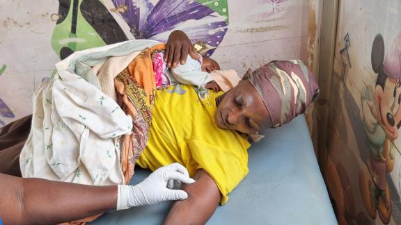 Woman with newborn baby receives contraceptive implant form healthcare providers in Kenya. 