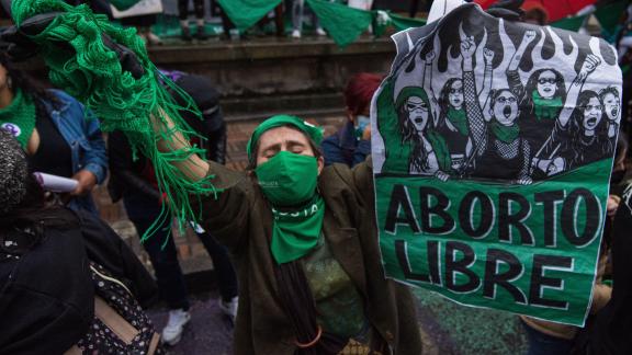 woman holding green flag from the Latin American feminist movement 