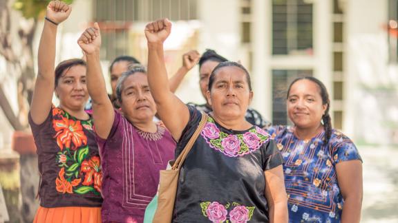 Group of women with raised fist.