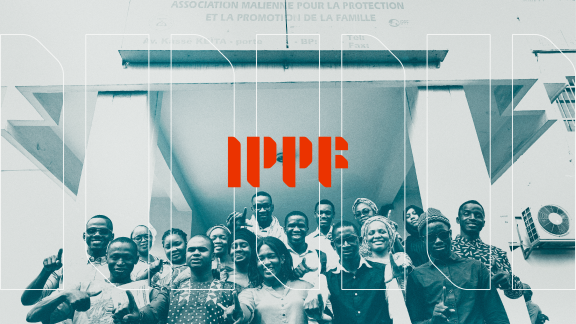 A group of people stand at the bottom of the picture with the IPPF logo in red above them.