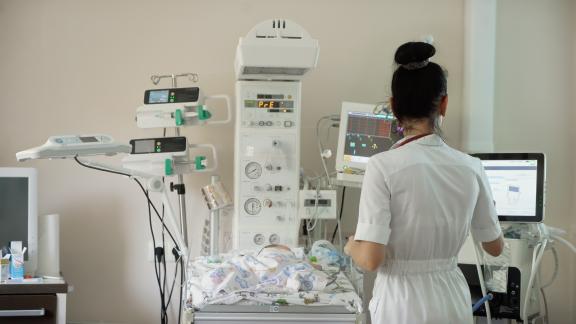 A healthcare professional monitors a newborn baby in a health centre in Ukraine