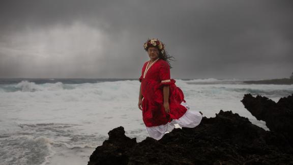 A portrait of Dean Tangata, Humanitarian Focal Point for the Cook Islands Family Welfare Association (CIFWA), in the ocean surrounding Rarotonga, Cook Islands