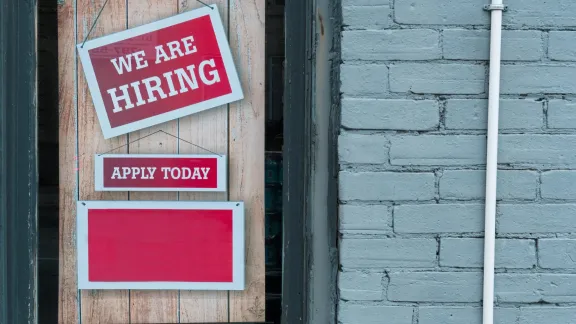 Red 'We Are Hiring' sign