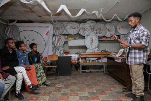 A volunteer at Makelle demonstrates to a group of young people how to put on a condom