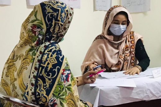 A woman speaks with a healthcare worker