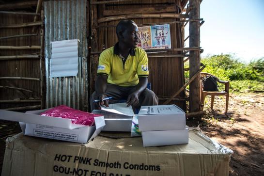 A RHU staff member distributes free condoms IPPF/Tommy Trenchard